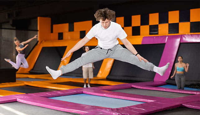 Teenagers at indoor trampoline park